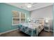 Bedroom with teal and gray walls, queen bed, and window at 518 Cordgrass Ln., Little River, SC 29566