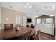 Dining area with wooden table and chairs, open to living room at 518 Cordgrass Ln., Little River, SC 29566