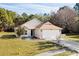 Tan house with brown roof, two-car garage, and yard at 518 Cordgrass Ln., Little River, SC 29566