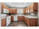 Galley kitchen with wood cabinets and tile flooring at 518 Cordgrass Ln., Little River, SC 29566