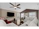 Living room with sectional sofa, hardwood floors, and large TV at 518 Cordgrass Ln., Little River, SC 29566