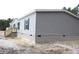 Gray vinyl siding house with brick base and wooden steps at 5225 Hwy 712, Galivants Ferry, SC 29544