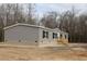 Gray vinyl siding house with a brick base and wooden steps at 5225 Hwy 712, Galivants Ferry, SC 29544