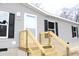 House entrance with wooden steps and gray siding at 5225 Hwy 712, Galivants Ferry, SC 29544