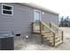 Side entrance with wooden steps and gray vinyl siding at 5225 Hwy 712, Galivants Ferry, SC 29544