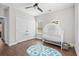 Bedroom with crib, closet, and playful rug at 5300 Juniper Bay Rd., Conway, SC 29527