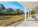 Front porch view of yard, trees, and distant car at 5300 Juniper Bay Rd., Conway, SC 29527