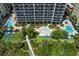 Aerial view of resort-style pool area with multiple pools, lounge chairs, and lush landscaping at 5308 N Ocean Blvd. # 601, Myrtle Beach, SC 29577