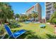 Ground level view of resort-style pool deck with lounge chairs and grassy areas at 5308 N Ocean Blvd. # 601, Myrtle Beach, SC 29577