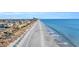 Aerial view of beach shoreline with ocean waves and birds at 5515 Porcher Dr., Myrtle Beach, SC 29577