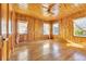 Bright living room with wood walls and floors, offering lots of natural light at 5515 Porcher Dr., Myrtle Beach, SC 29577