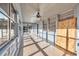 Screened porch with ceiling fan and view of the backyard at 5515 Porcher Dr., Myrtle Beach, SC 29577