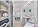 Bright bathroom with a pedestal sink, open shelving, and framed mirror at 5523 N Ocean Blvd. # 1601, Myrtle Beach, SC 29577