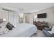 Well-lit bedroom featuring a comfortable bed, closet, and dresser with a mounted TV at 5523 N Ocean Blvd. # 1601, Myrtle Beach, SC 29577