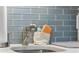 Modern kitchen sink with pull-down faucet and blue tile backsplash at 5523 N Ocean Blvd. # 1601, Myrtle Beach, SC 29577