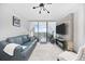 Cozy living room with a leather sofa, light rug, and a balcony with ocean views at 5523 N Ocean Blvd. # 1601, Myrtle Beach, SC 29577