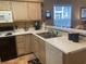 Galley kitchen with light wood cabinets and white appliances at 557 White River Dr. # 12A, Myrtle Beach, SC 29579