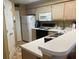 Galley kitchen with light wood cabinets and white appliances at 557 White River Dr. # 12A, Myrtle Beach, SC 29579