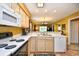 Galley kitchen with light wood cabinets and white appliances at 557 White River Dr. # 12A, Myrtle Beach, SC 29579