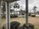 Screened porch with table and chairs overlooking pool at 557 White River Dr. # 12A, Myrtle Beach, SC 29579