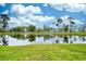 Scenic pond reflecting trees under a partly cloudy sky at 557 White River Dr. # 12A, Myrtle Beach, SC 29579