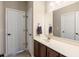 Bathroom with dark wood vanity, beige countertop, and a large mirror at 569 Miromar Way, Myrtle Beach, SC 29588