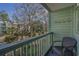 Private balcony overlooking a courtyard with trees and seating at 5905 South Kings Hwy. # 4205, Myrtle Beach, SC 29575