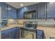 Well-equipped kitchen with stainless steel appliances and blue cabinets at 5905 South Kings Hwy. # 4205, Myrtle Beach, SC 29575