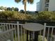 Balcony with ocean view and small table at 601 Retreat Beach Circle # 128, Pawleys Island, SC 29585