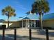 Main entrance to community center with palm trees and blue roof at 601 Retreat Beach Circle # 128, Pawleys Island, SC 29585