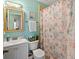 Clean bathroom with a shower/tub combo and flamingo-themed decor at 703 3Rd Ave. S, North Myrtle Beach, SC 29582