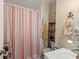 Clean bathroom with a shower/tub combo and striped shower curtain at 703 3Rd Ave. S, North Myrtle Beach, SC 29582