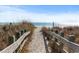 Sandy beach access path with wooden fence at 703 3Rd Ave. S, North Myrtle Beach, SC 29582