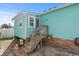 Quaint teal home with wooden steps and welcoming decor at 703 3Rd Ave. S, North Myrtle Beach, SC 29582