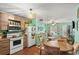 Open kitchen with breakfast nook, wood cabinets, and view into living room at 703 3Rd Ave. S, North Myrtle Beach, SC 29582