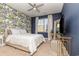 Bedroom with patterned wall, ceiling fan, and neutral bedding at 771 Flowering Branch Ave., Little River, SC 29566