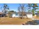 White house with blue accents, wooden porch, and a spacious yard at 789 University Forest Circle, Conway, SC 29526