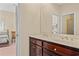 Double vanity bathroom with dark wood cabinets and a view of the bedroom at 8223 Forest Lake Dr., Conway, SC 29526