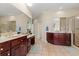 Elegant bathroom with double sinks, dark wood cabinets, and a large shower at 8223 Forest Lake Dr., Conway, SC 29526