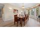 Elegant dining room featuring hardwood floors, a wooden table, and water views at 8223 Forest Lake Dr., Conway, SC 29526