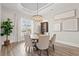 Elegant dining room with round table, neutral decor, and hardwood floors at 9387 Venezia Circle, Myrtle Beach, SC 29579