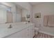 Double vanity bathroom with white cabinets and a large mirror at 9815 W Highway 19, Loris, SC 29569