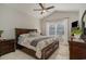 Main bedroom with wood furniture and large window overlooking backyard at 9815 W Highway 19, Loris, SC 29569