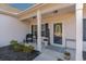 Inviting front porch with rocking chair and decorative planters at 9815 W Highway 19, Loris, SC 29569