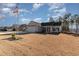 House exterior with front yard, landscaping, and American flag at 9815 W Highway 19, Loris, SC 29569