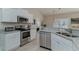 Modern kitchen with stainless steel appliances and white shaker cabinets at 9815 W Highway 19, Loris, SC 29569