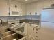 White cabinets, granite countertops, and stainless steel appliances in this galley kitchen at 9820 Queensway Blvd. # 206, Myrtle Beach, SC 29572