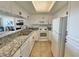 Bright kitchen featuring white cabinets, granite countertops, and stainless steel appliances at 9820 Queensway Blvd. # 206, Myrtle Beach, SC 29572