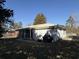 A backyard view showcasing the home's siding, metal roof, and outdoor patio area at 10 Buckthorn St., Andrews, SC 29510