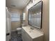 Modern bathroom features a black framed mirror, vanity and tub/shower at 10 Buckthorn St., Andrews, SC 29510